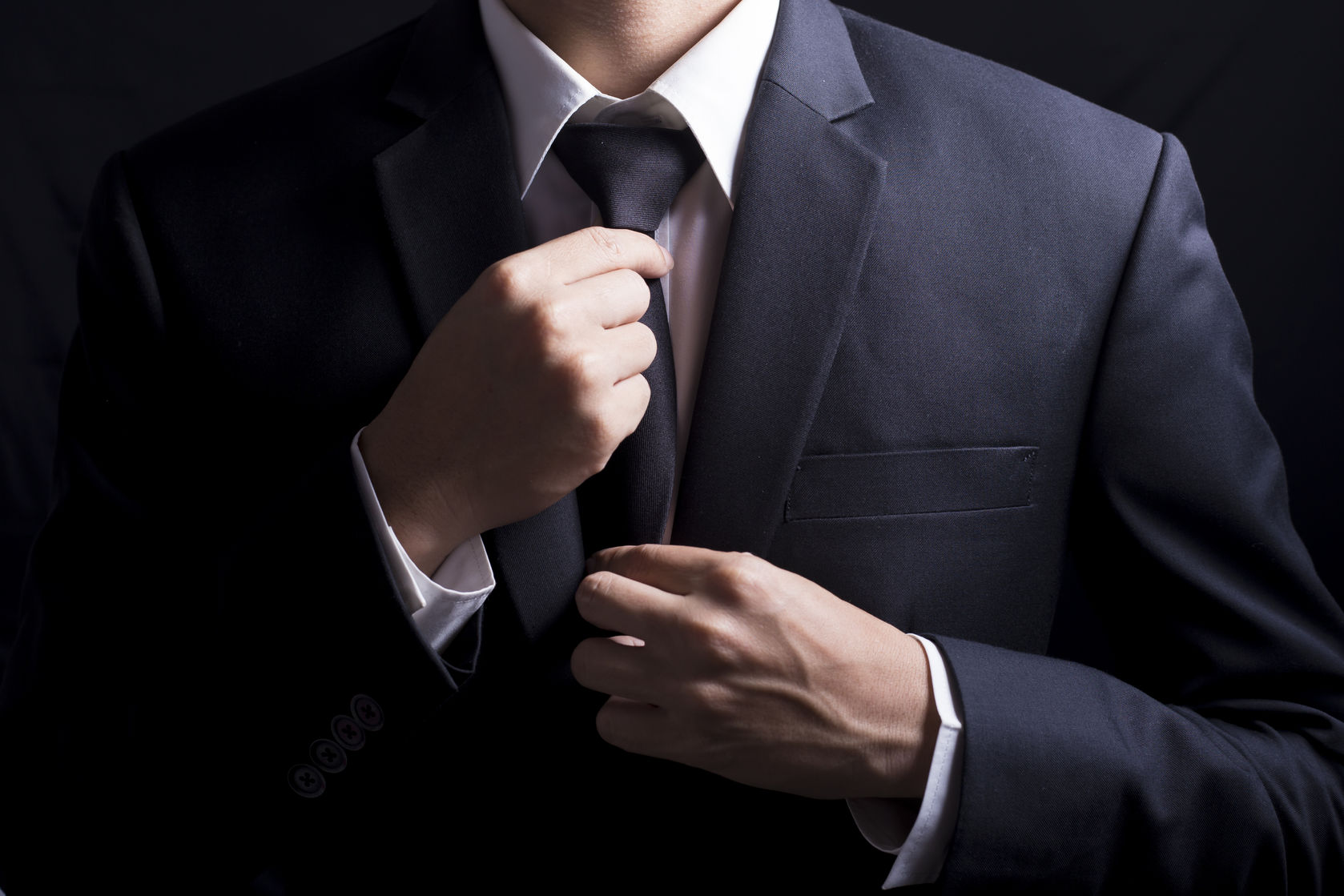businessman adjust necktie his suit