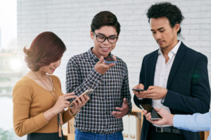 young businessman using voice search on his smartphone