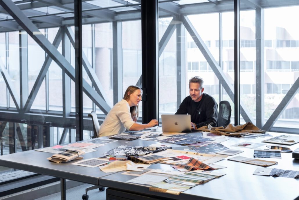 Two professionals working on a laptop; work tech linkedin concept